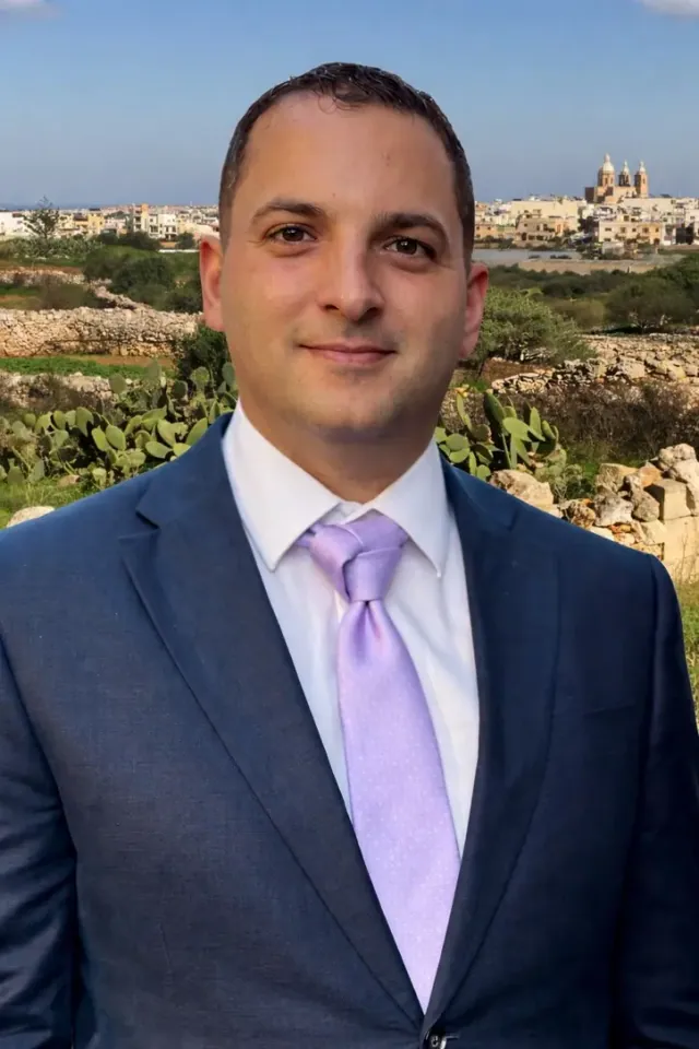 Ryan Tanti liebes libsa blu, b’Ħad-Dingli fl-isfond